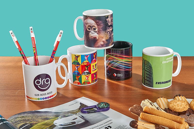 Promotional mugs on a desk from Prince William Pottery