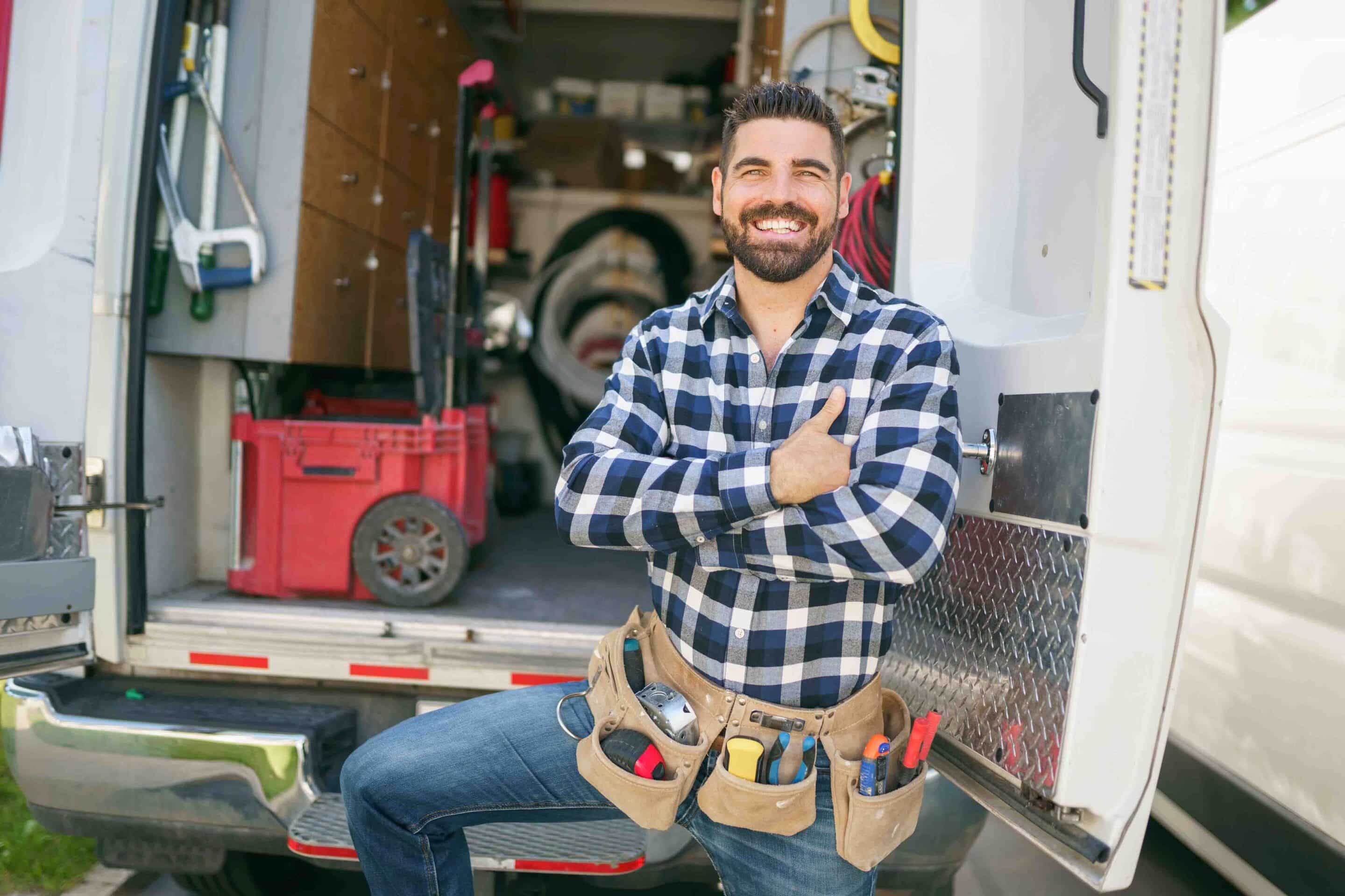 Electrician standing by van, Best Ways to Advertise Your Electrical Business