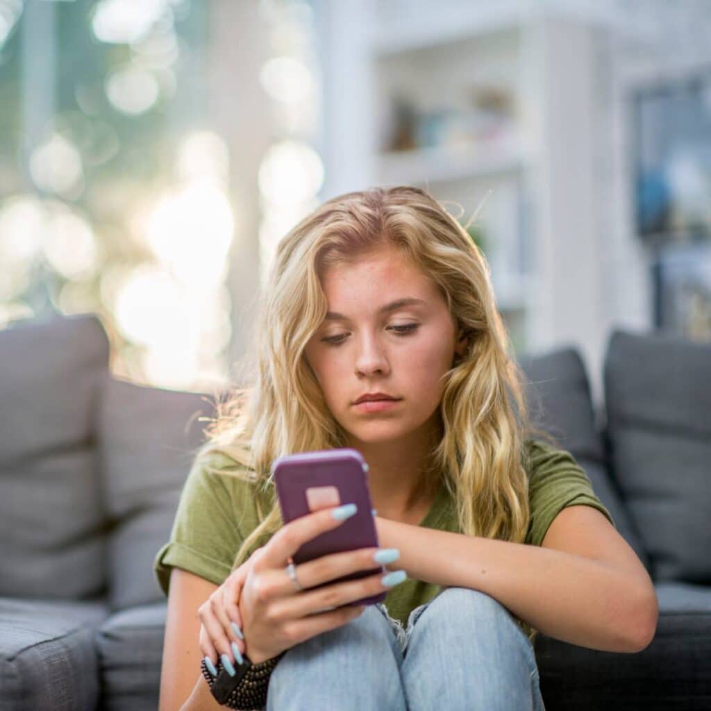 girl in the uk looking at ads on her phone